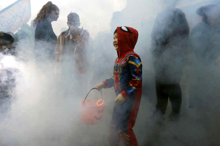 JoeJoe Willis, 5, of Grove City, runs through the thick smoke billowing from a fog machine at the annual Boo Off Broadway trick-or-treat event, hosted by Grove City Parks and Recreation.  (Shane Flanigan / ThisWeek Community News)